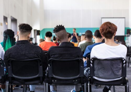 Teenagers in classroom discussing mental health