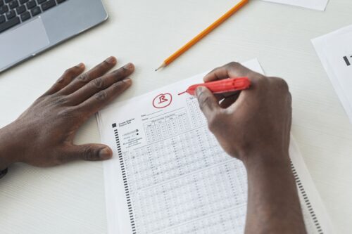 Teacher marks a paper awarding it a b plus