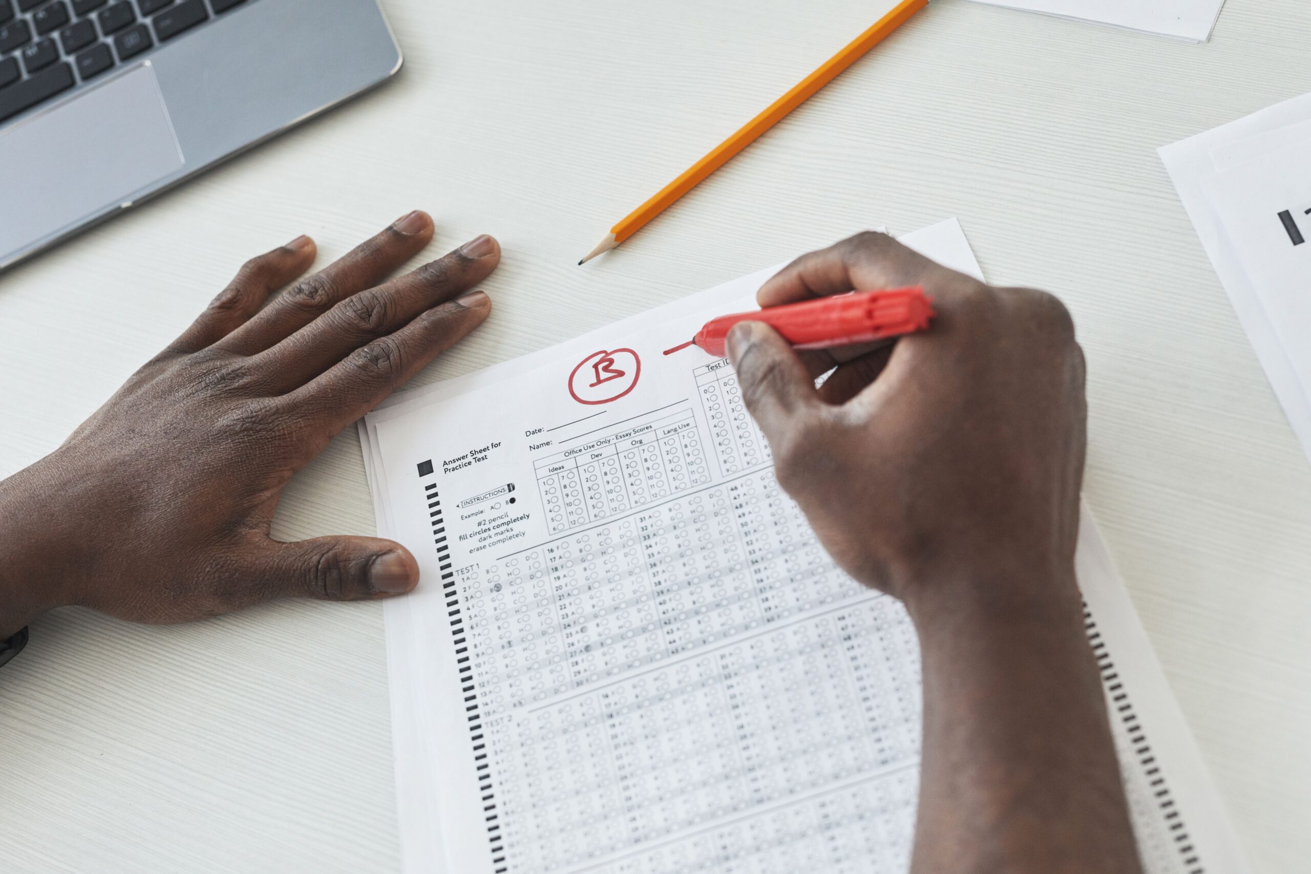 Teacher marks a paper awarding it a b plus